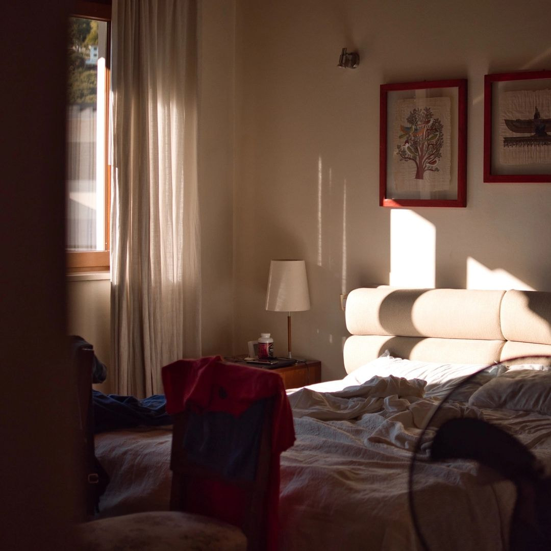 a bedroom with a bed and a lamp