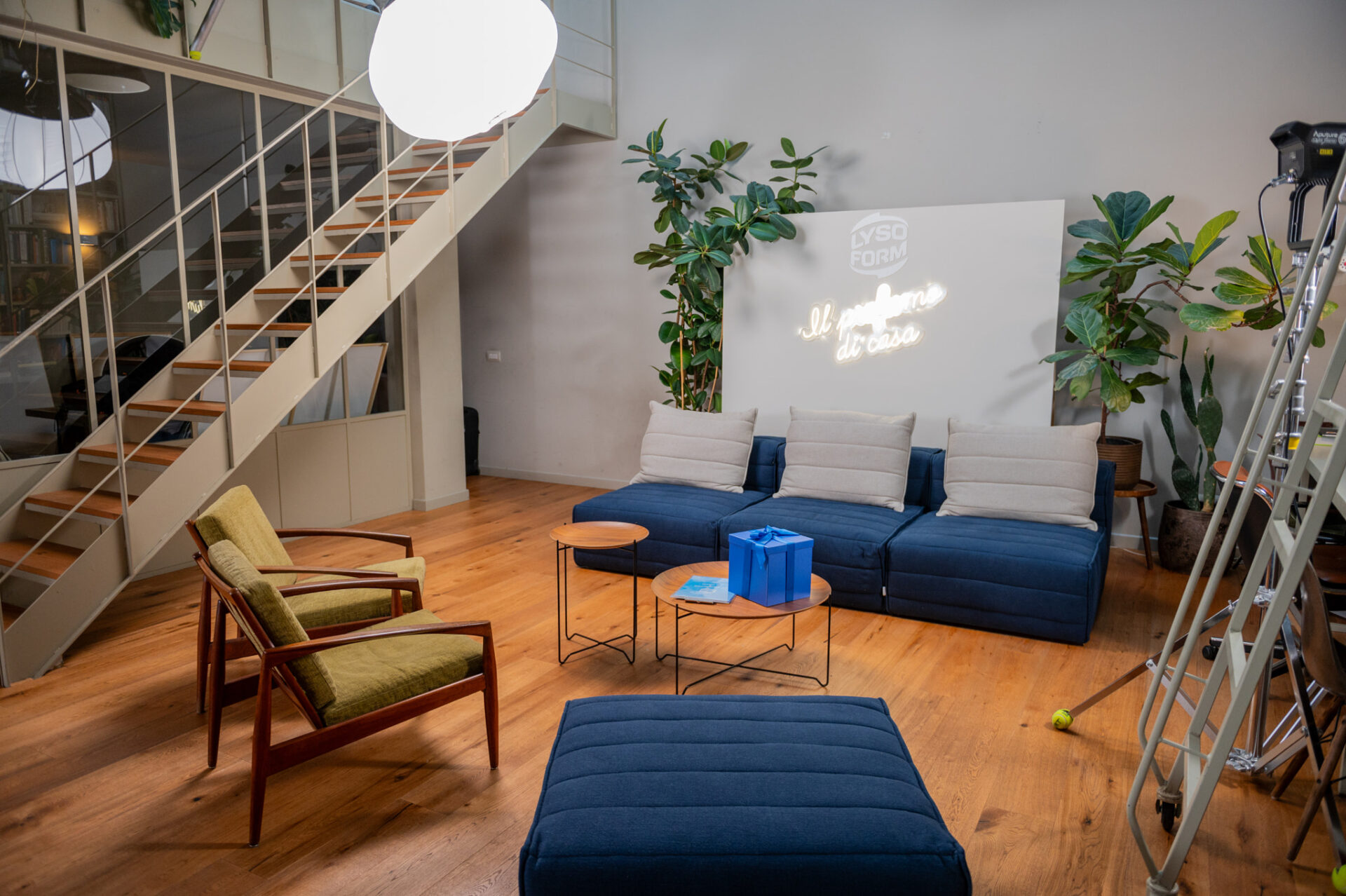 a living room with a blue couch and a blue chair