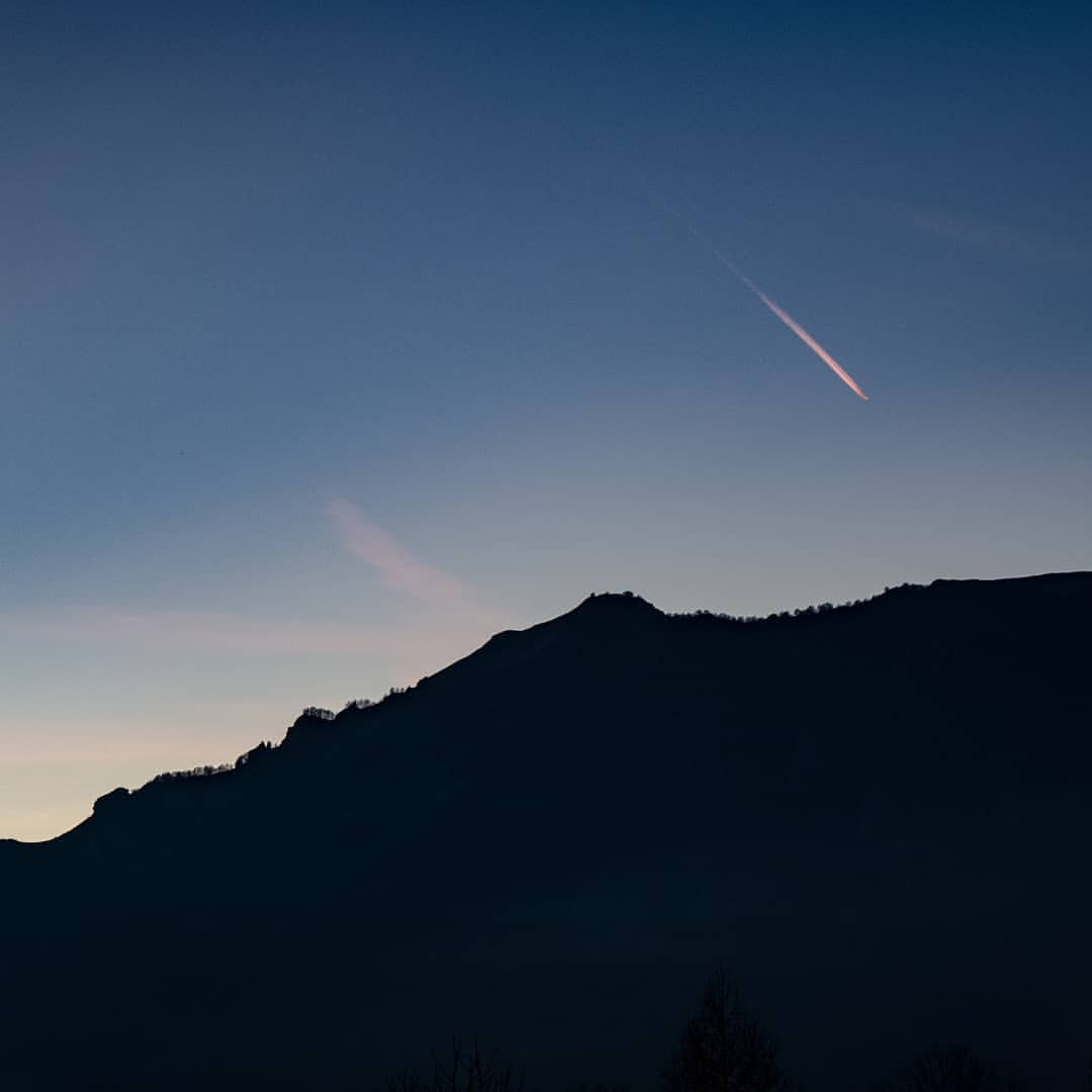 a mountain with a trail of smoke