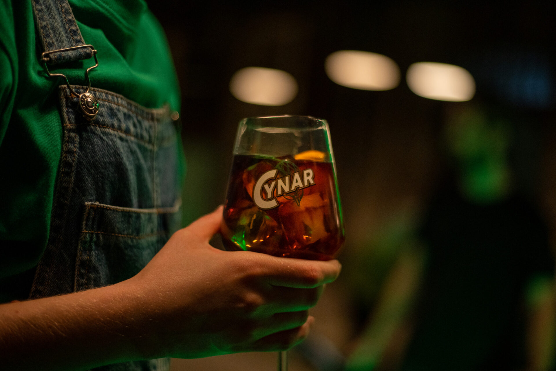 a person holding a glass of beer