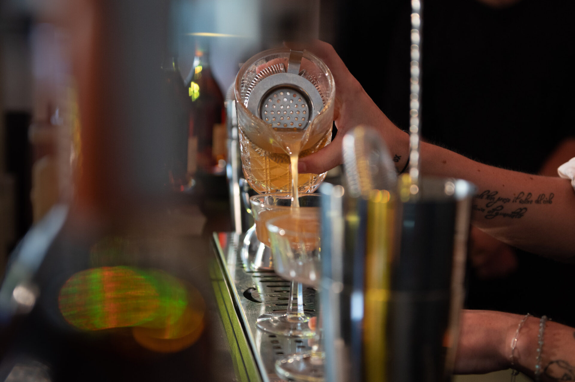 a person pouring liquid into a glass